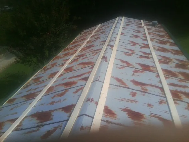 Rusted metal roof panels with new wood purlins before replacement — Storm Damage Roof Repair in Indian Head by Roofing Brothers